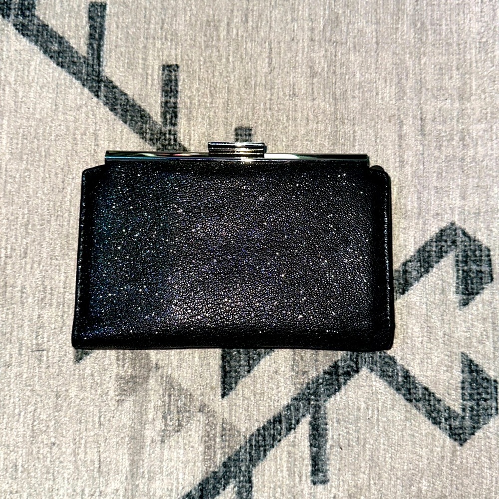 Woman’s Abas black sparkling wallet. With strong latch and tons of space.